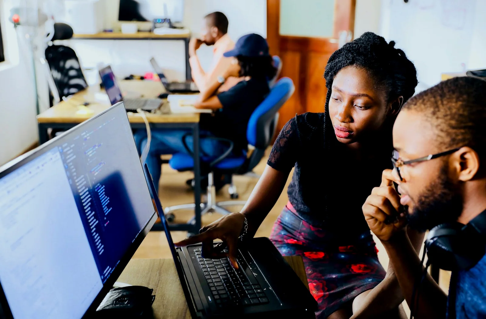 Technology professionals conducting a code review in a Lagos workspace