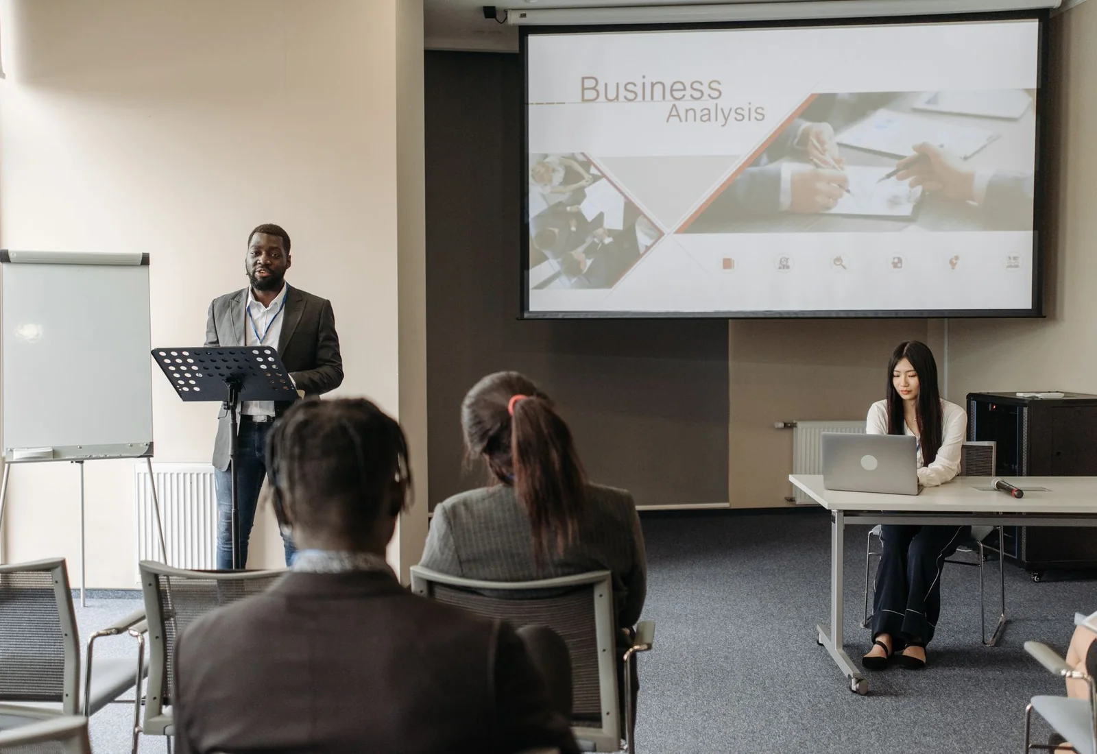 An instructor delivering a business training session to adult participants